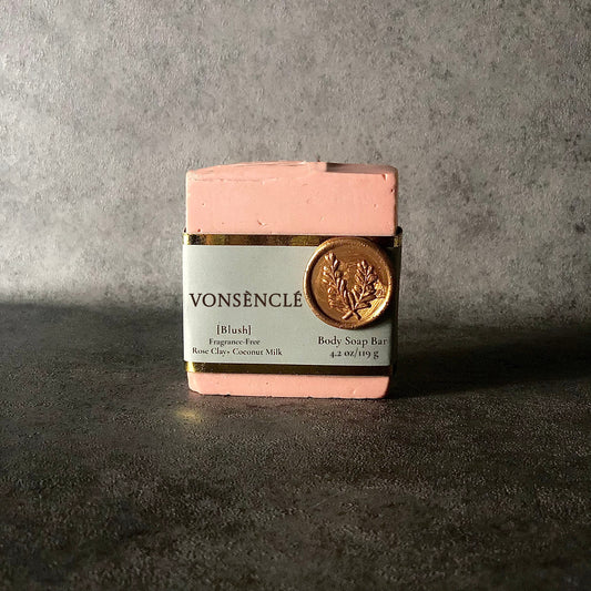 Pink soap bar with a grey and gold foil label with a wax stamped seal