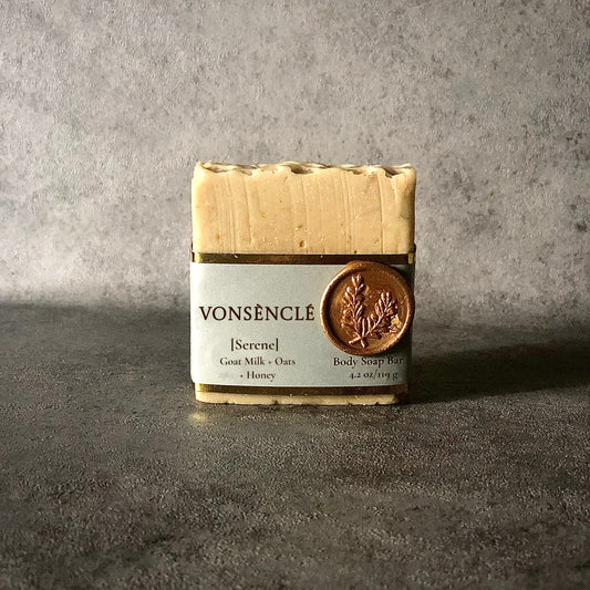 Square-shaped soap bar with gray gold foiled wrapped around label