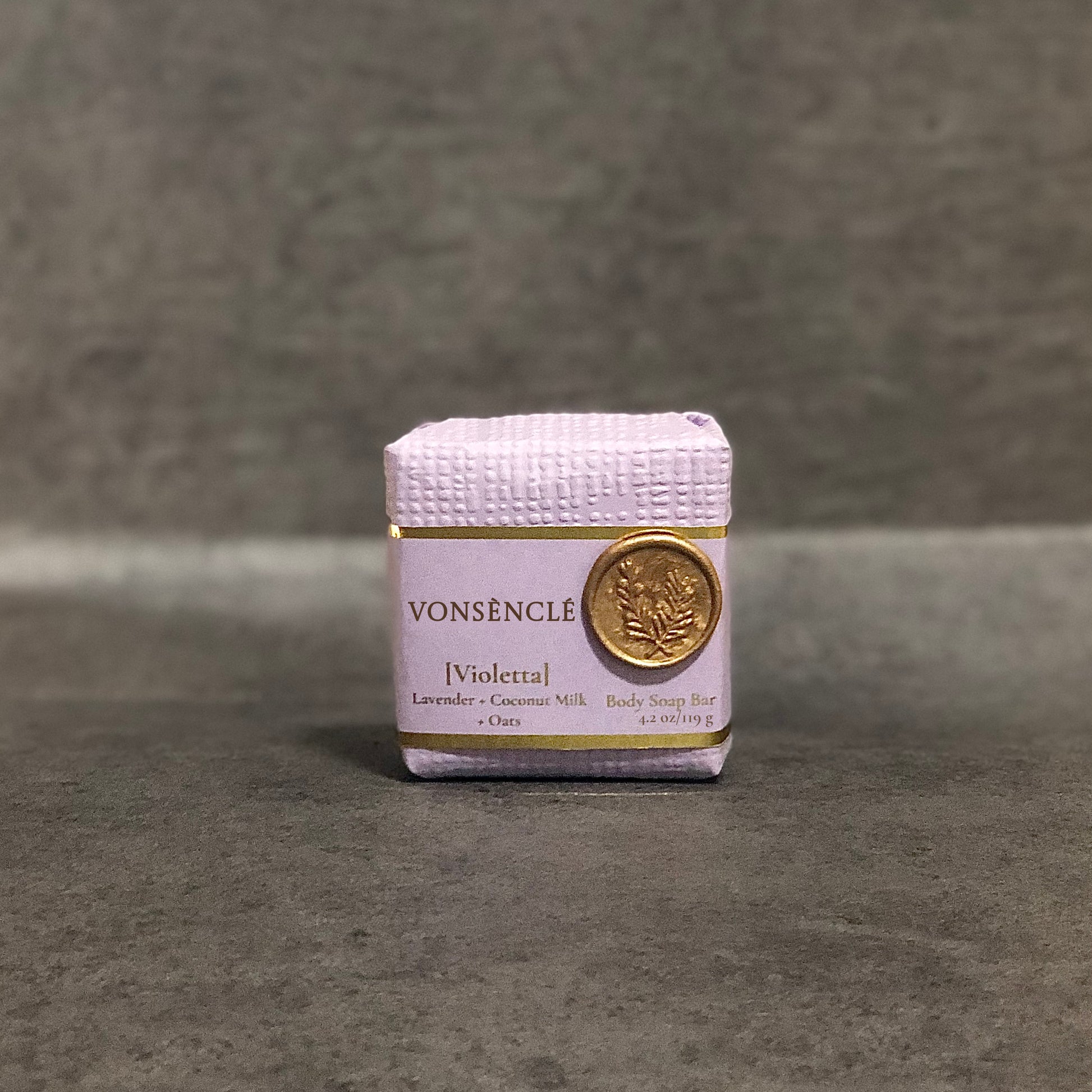 Vonsènclé soap bar wrapped in a lavender colored packaging with a gold foil label and a wax seal