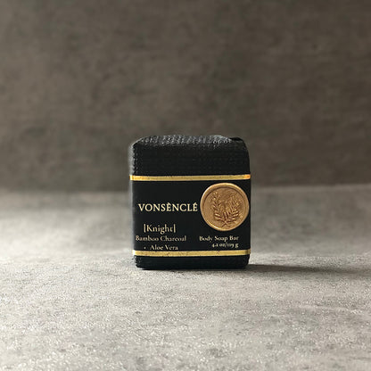 Vonsènclé body soap bar with black packaging on a gray surface.
